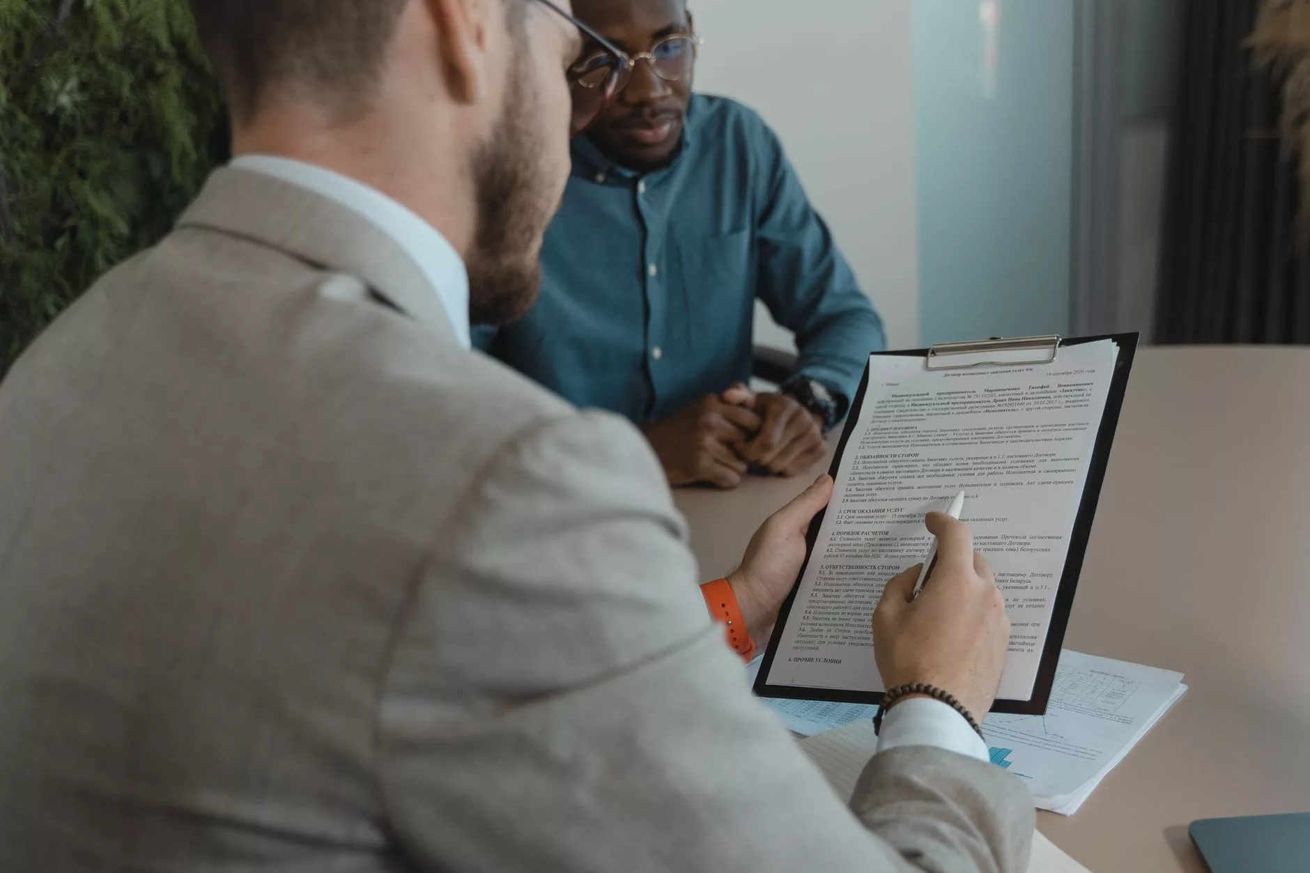Navigating the Market: Finding and Evaluating Talent hiring managers reviewing professional portfolios and resumes on a wooden table