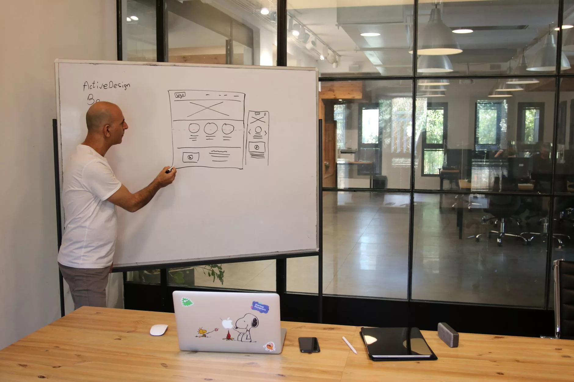 Phase 1: Understanding the Foundation and Planning Your WordPress Website notebook with website wireframe sketches and laptop on office desk