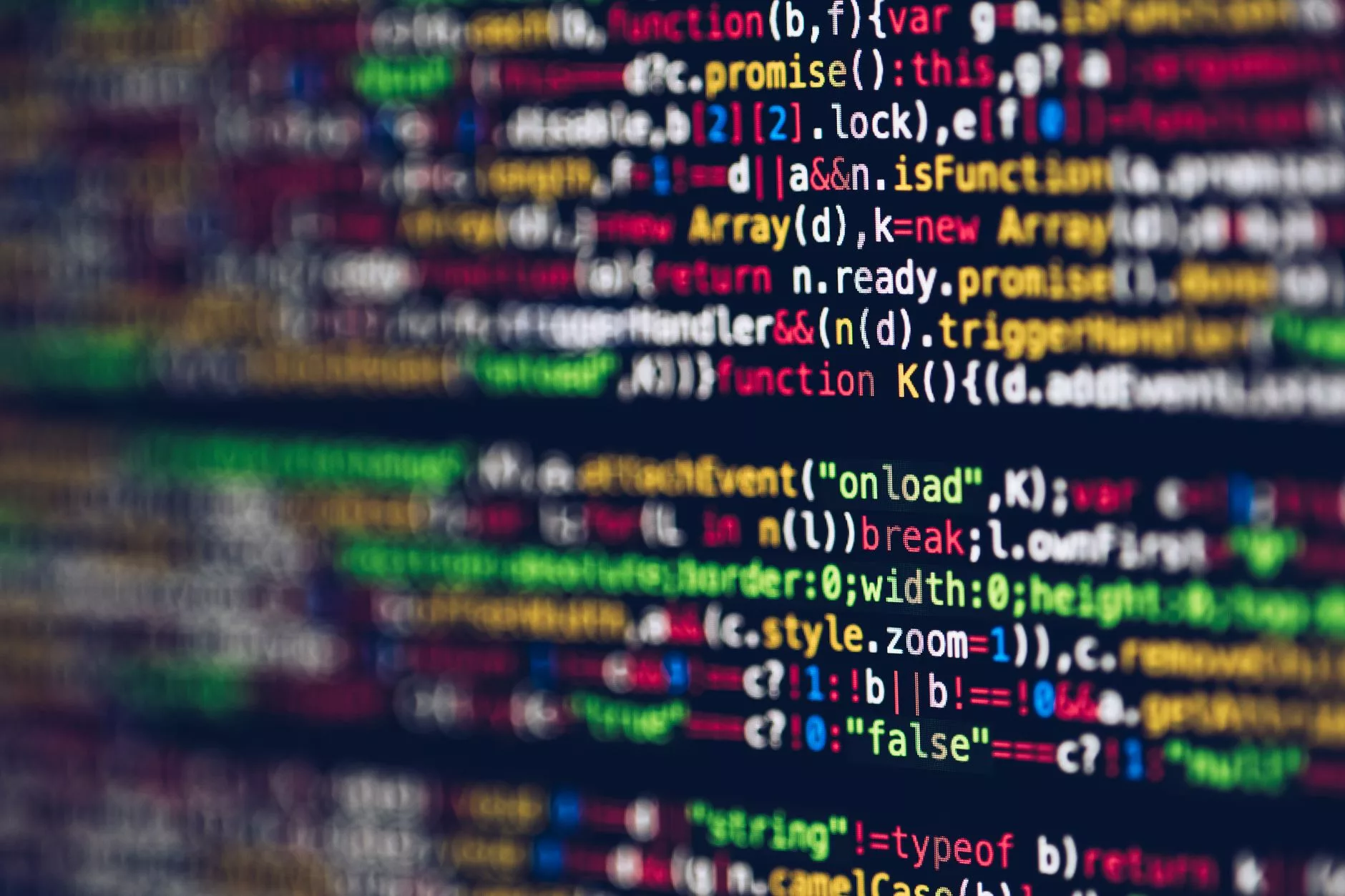 What is WordPress and Why Is It Used Today? Lines of open-source website code displayed on a computer screen in a dark workspace.