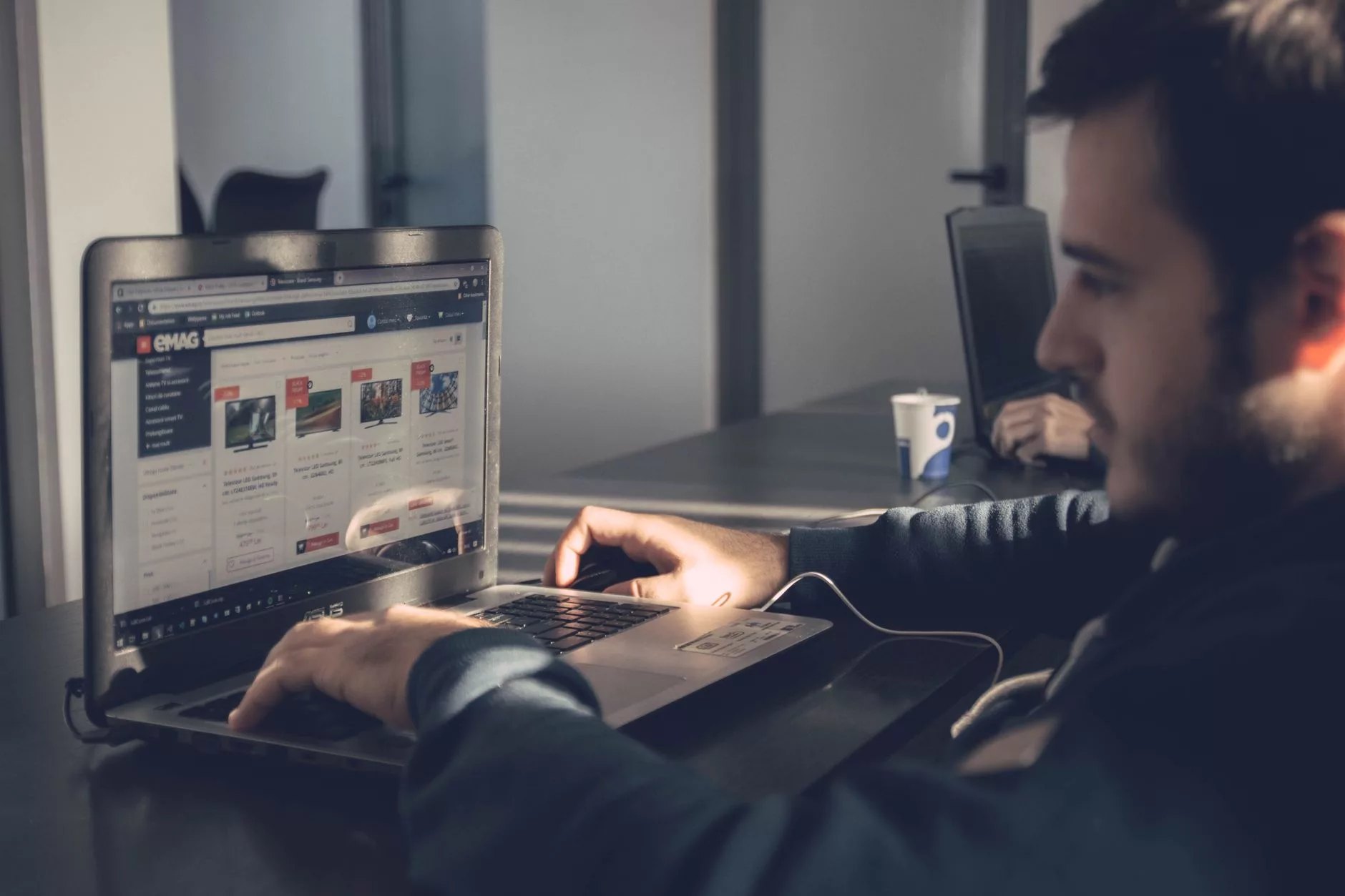 What Is Google Ads and How Does It Work? entrepreneur reviewing online search campaign results on a laptop