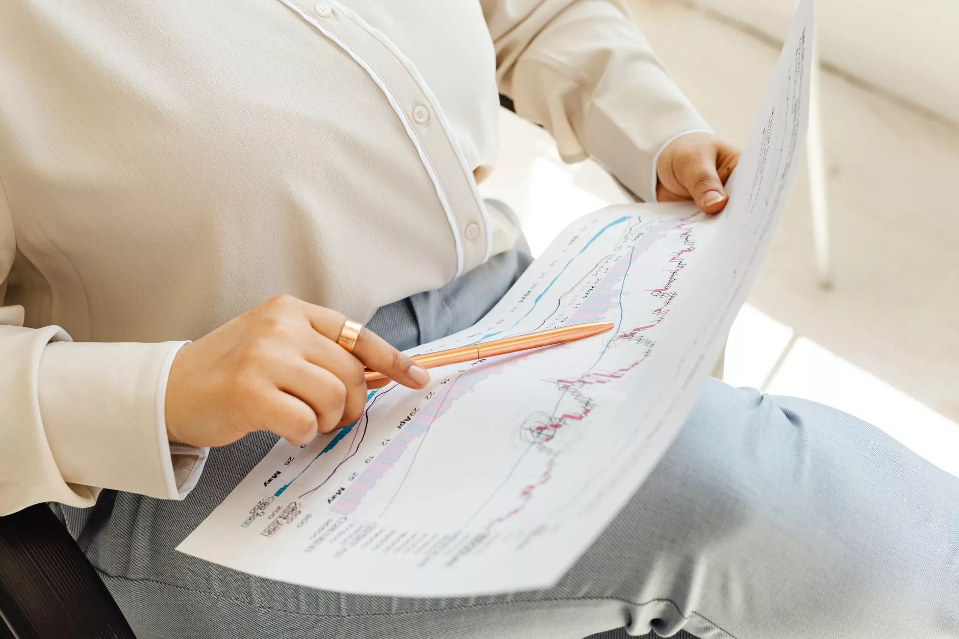 Aligning Traffic with Business Impact in Your Digital Marketing Strategy close up of a business professional reviewing revenue growth graphs on paper