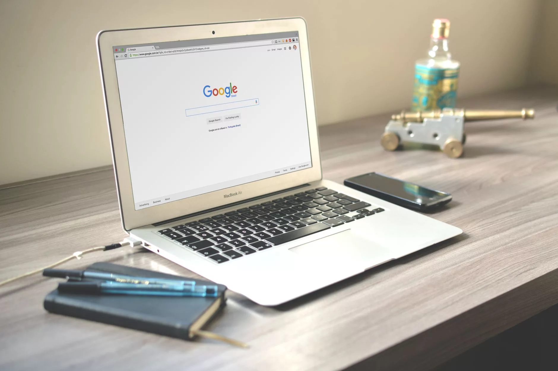 laptop screen displaying a local business map search result on wooden desk