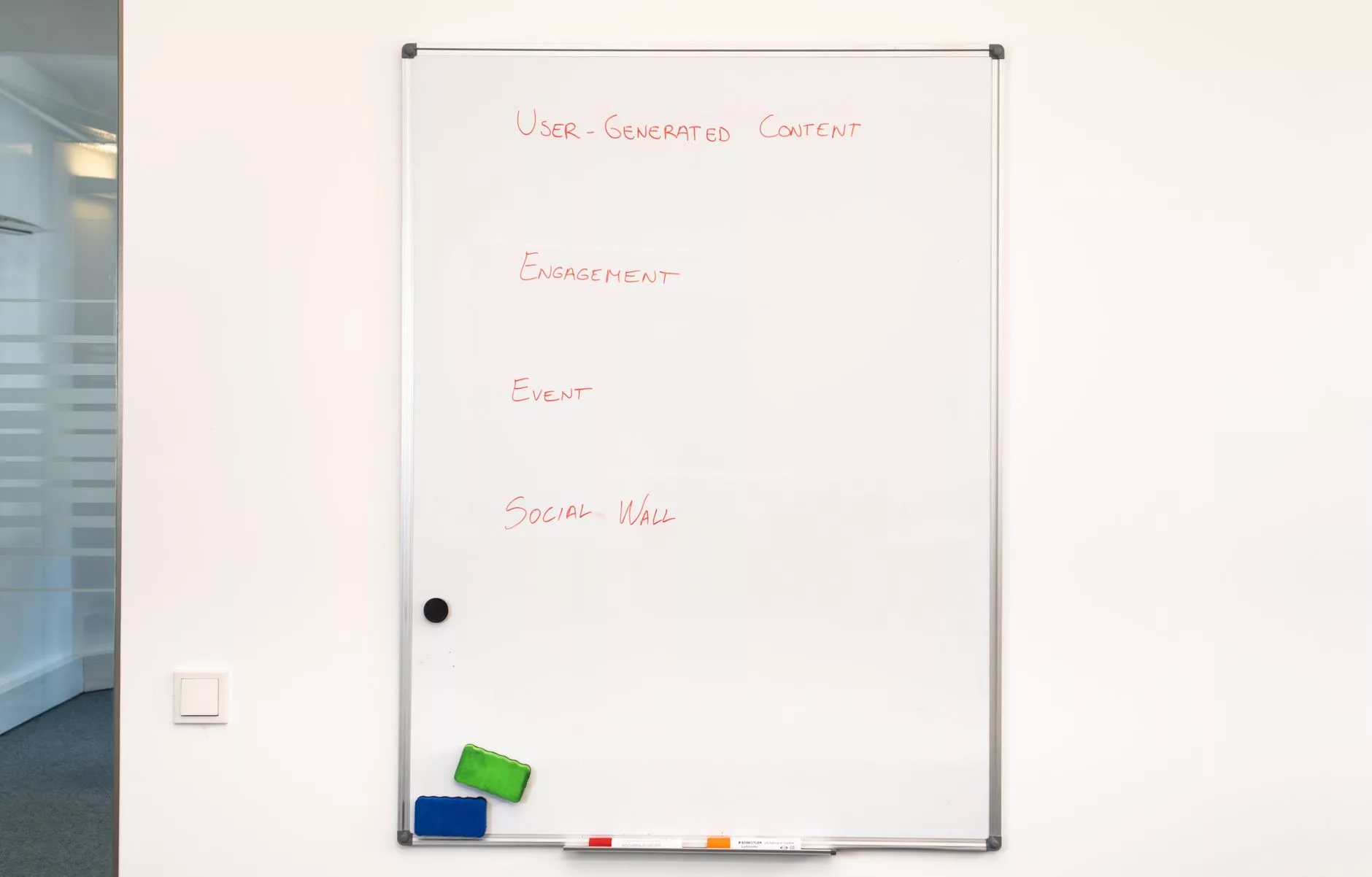 business team brainstorming content ideas using sticky notes on a glass office wall